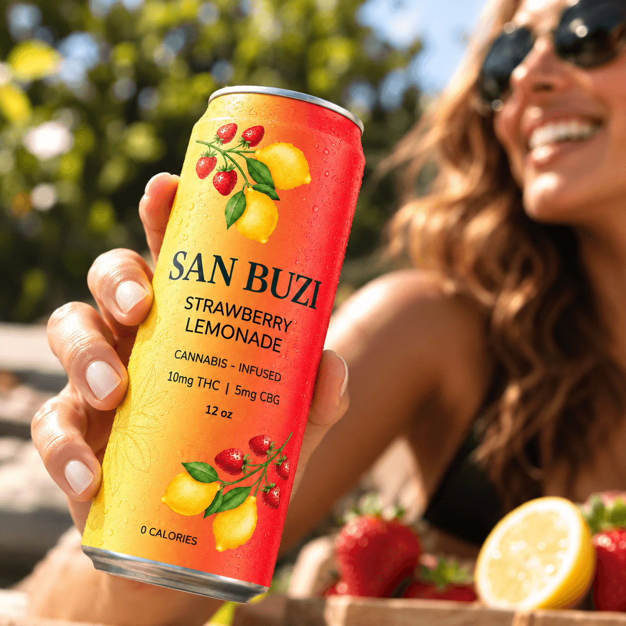 Close-up of a hand holding a San Buzi Strawberry Lemonade outdoors